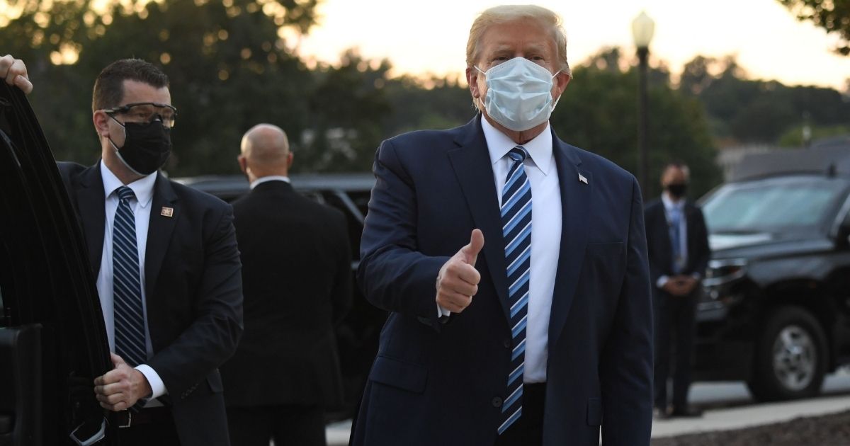 TOPSHOT - US President Donald Trump gestures after walking out of Walter Reed Medical Center in Bethesda, Maryland before heading to Marine One on October 5, 2020, to return to the White House after being discharged. - Trump announced he would be "back on the campaign trail soon", just before returning to the White House from a hospital where he was being treated for Covid-19.