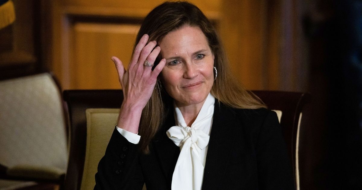 Judge Amy Coney Barrett, President Donald Trump's nominee for the US Supreme Court, looks on as she meets with Senators on Capitol Hill in Washington, DC on October, 1, 2020.