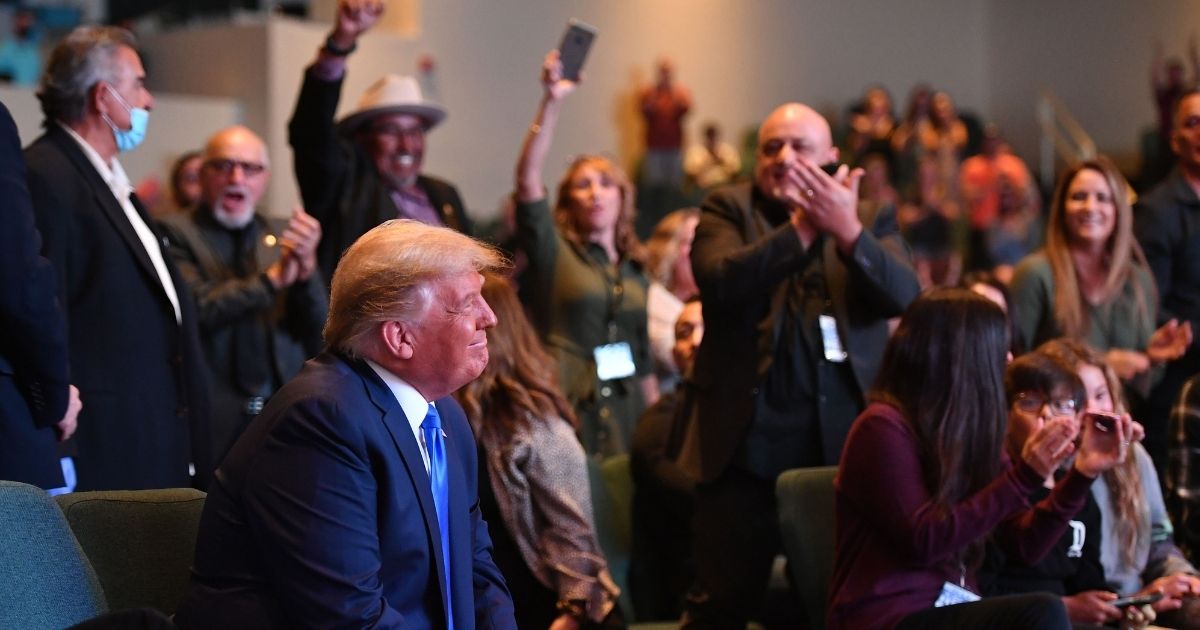 President Donald Trump is cheered by the congregation as he attends a Sunday service at the International Church of Las Vegas in Las Vegas, Nevada, during a campaign swing through the battleground state.