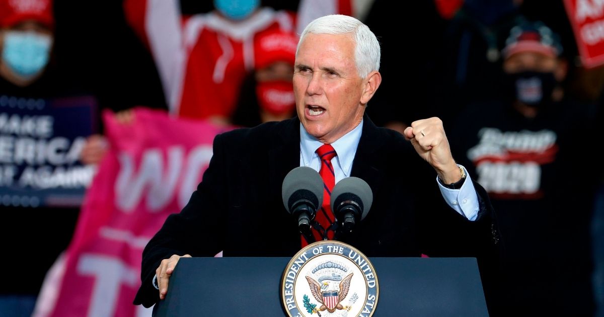 Vice President Mike Pence campaigns hard Thursday at a "Make America Great Again!" campaign event at Oakland County International Airport in Waterford, Michigan.