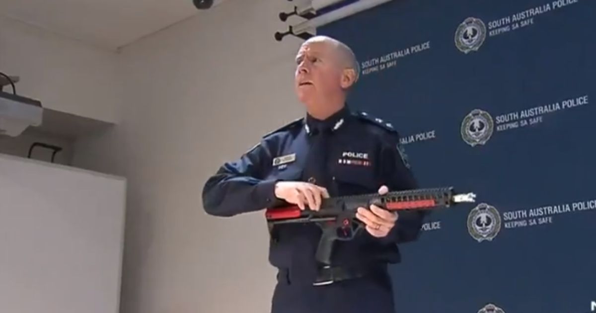 A South Australian Police officer showing off a newly-illegal gel blaster toy.