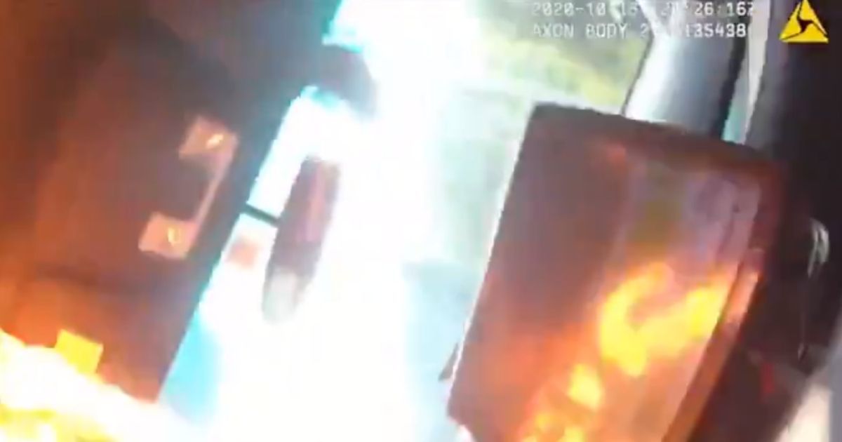 A police officer in Seattle is healing from minor burns after a man threw a blazing piece of wood into a police cruiser in the city on Thursday.