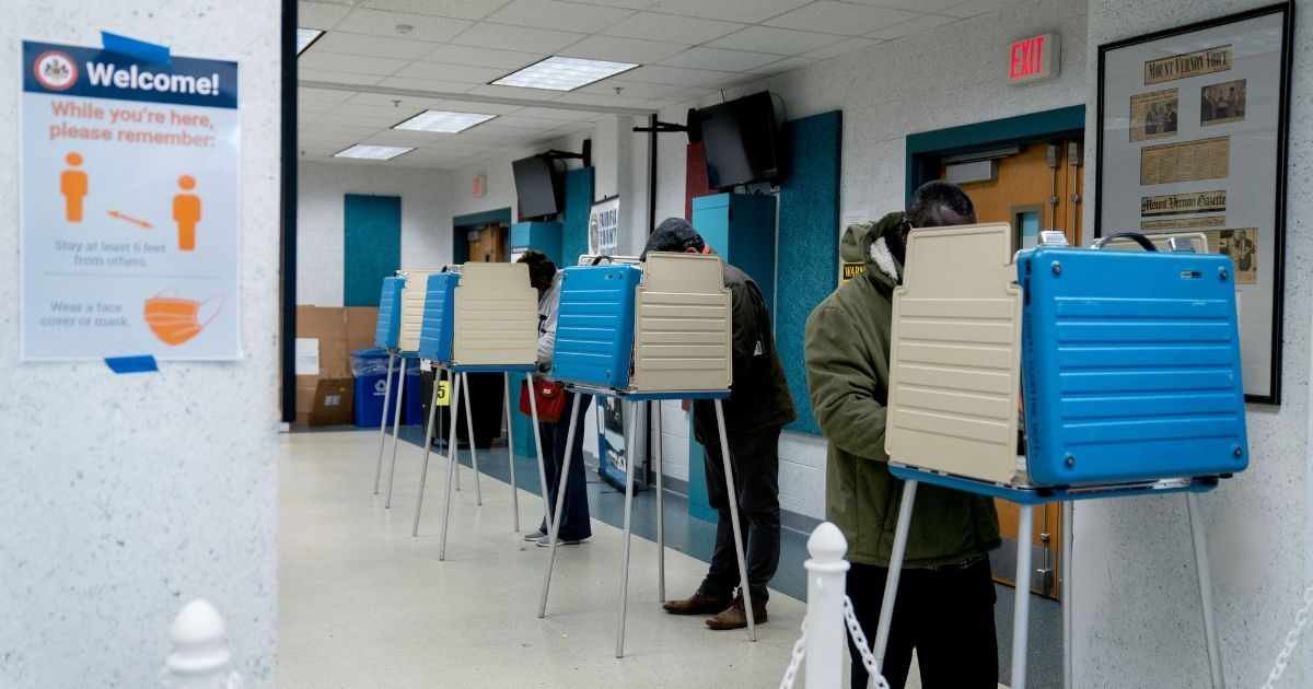 Voters fill out their ballots at an early voting center at the Mount Vernon Governmental Center on Saturday in Alexandria, Virginia.