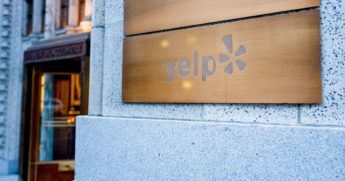 The above stock image shows a close-up of a sign at the headquarters of travel and restaurant rating company Yelp in San Francisco.