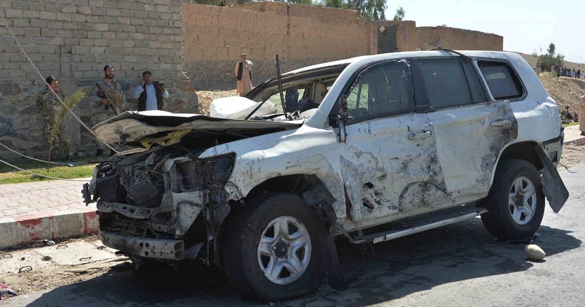 Afghan security forces inspect the site of a car bomb attack in Laghman province on Oct. 5, 2020.