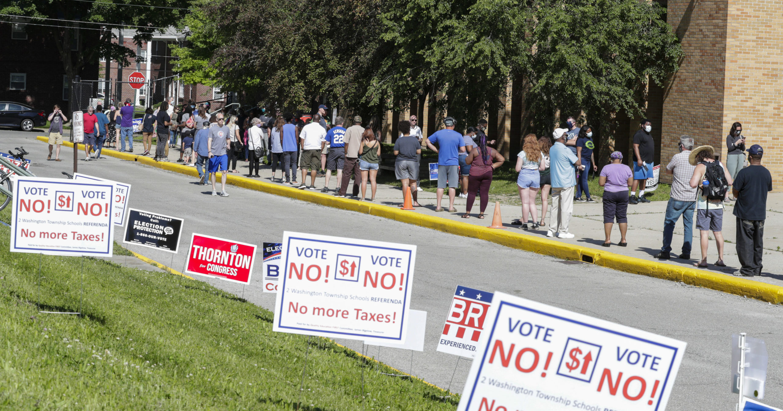 In this June 2, 2020, file photo, voters wait in a line outside Broad Ripple High School to vote in the Indiana primary in Indianapolis.