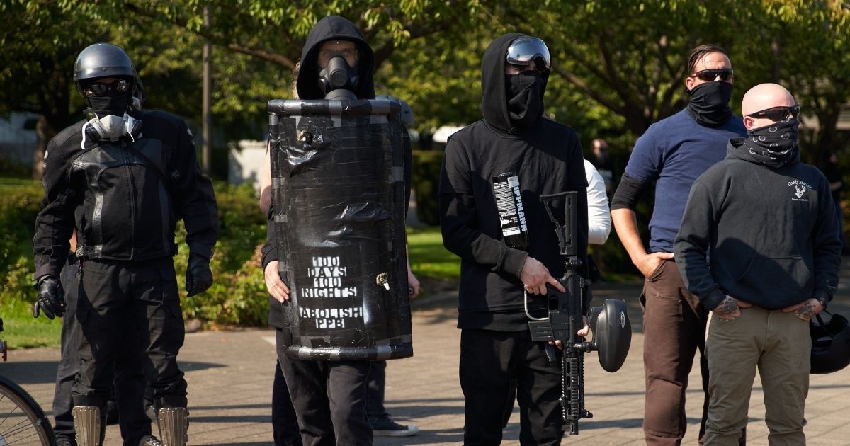 Members of antifa stand in the street as Trump supporters and members of the conservative groups Patriot Prayer and Proud Boys gather in Salem, Oregon, on Sept. 7, 2020.