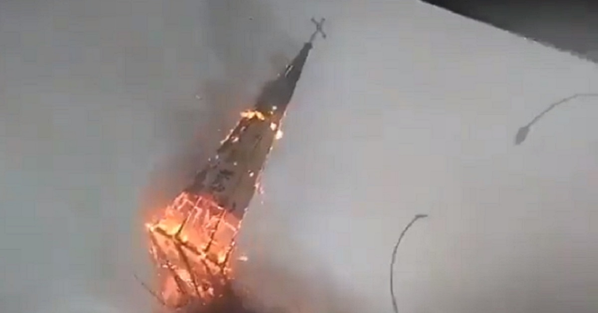 The spire of the church of La Asuncion in Santiago, Chile, falls to the ground in flames on Sunday.