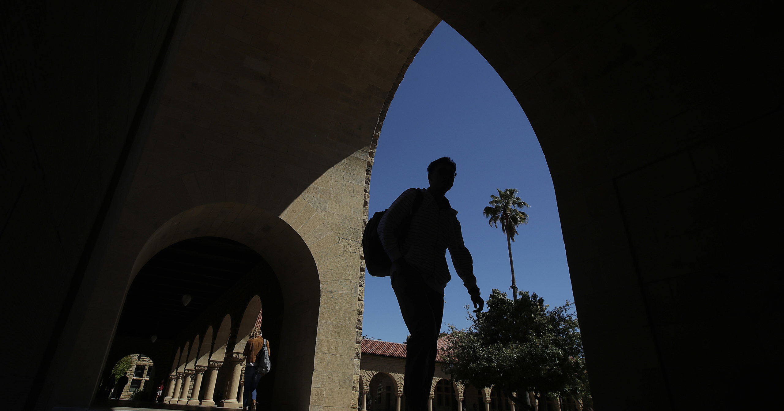 In this April 9, 2019, file photo, pedestrians walk on the campus of Stanford University in Stanford, California.