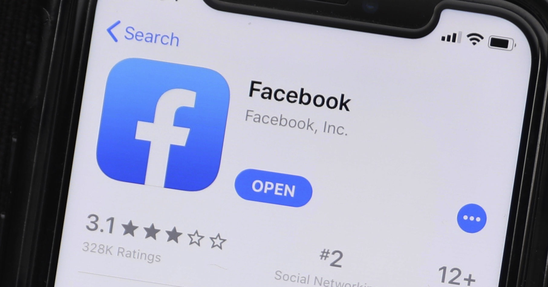 This July 30, 2019, file photo shows update information for the Facebook application on a mobile phone displayed at a store in Chicago.