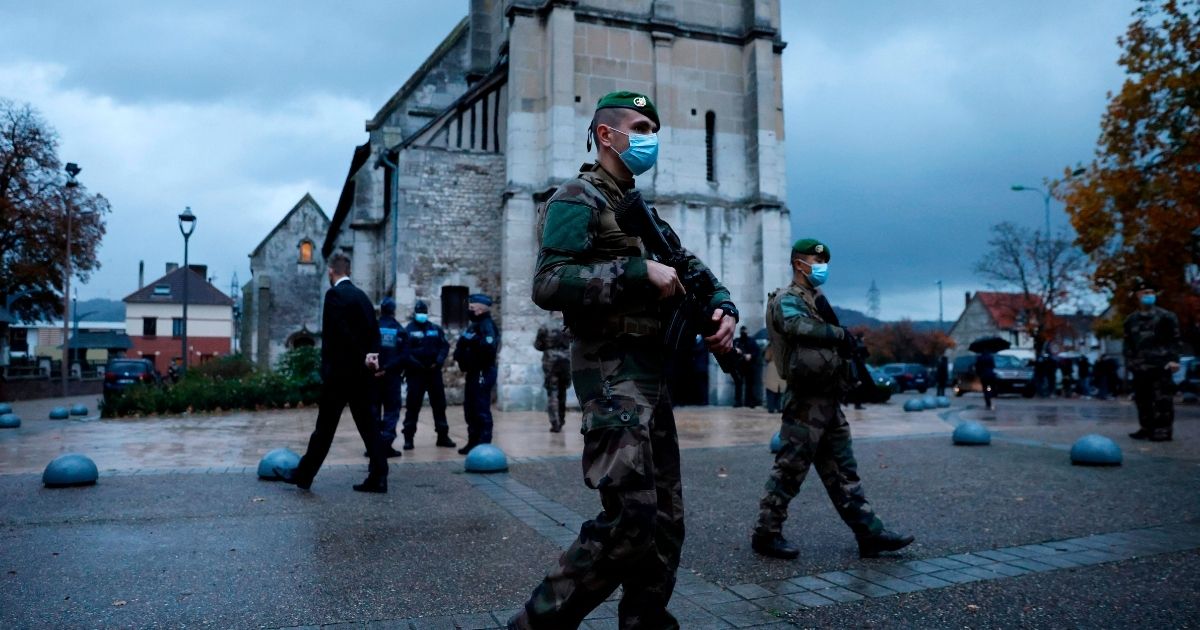 French soldiers patrol in front of a church in northwestern France on Oct. 31, 2020, two days after a knife attacker killed three churchgoers in Nice.