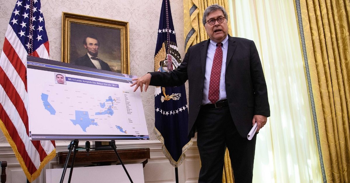 Attorney General William Barr discusses operations against the MS-13 gang during a briefing with President Donald Trump and top law enforcement officials in the Oval Office at the White House in Washington, D.C., on July 15, 2020.