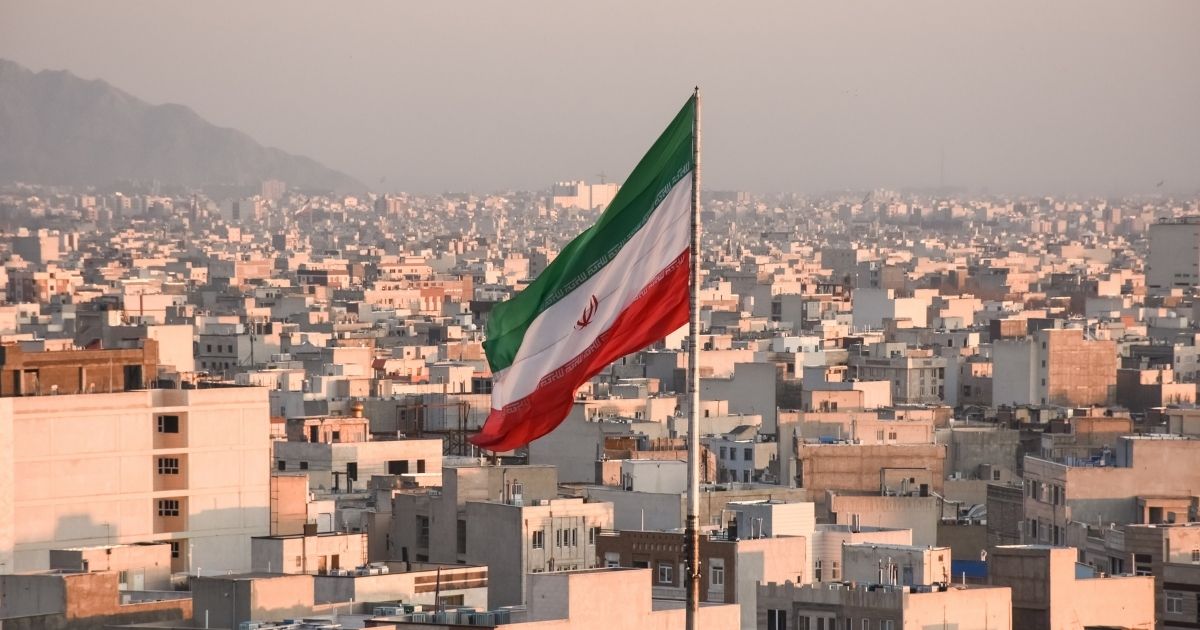 The Iranian flag flies over Tehran in this stock image.