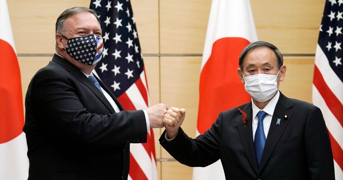Japanese Prime Minister Yoshihide Suga and US Secretary of State Mike Pompeo greet prior to their meeting at the prime minister's office in Tokyo on Oct. 6, 2020.