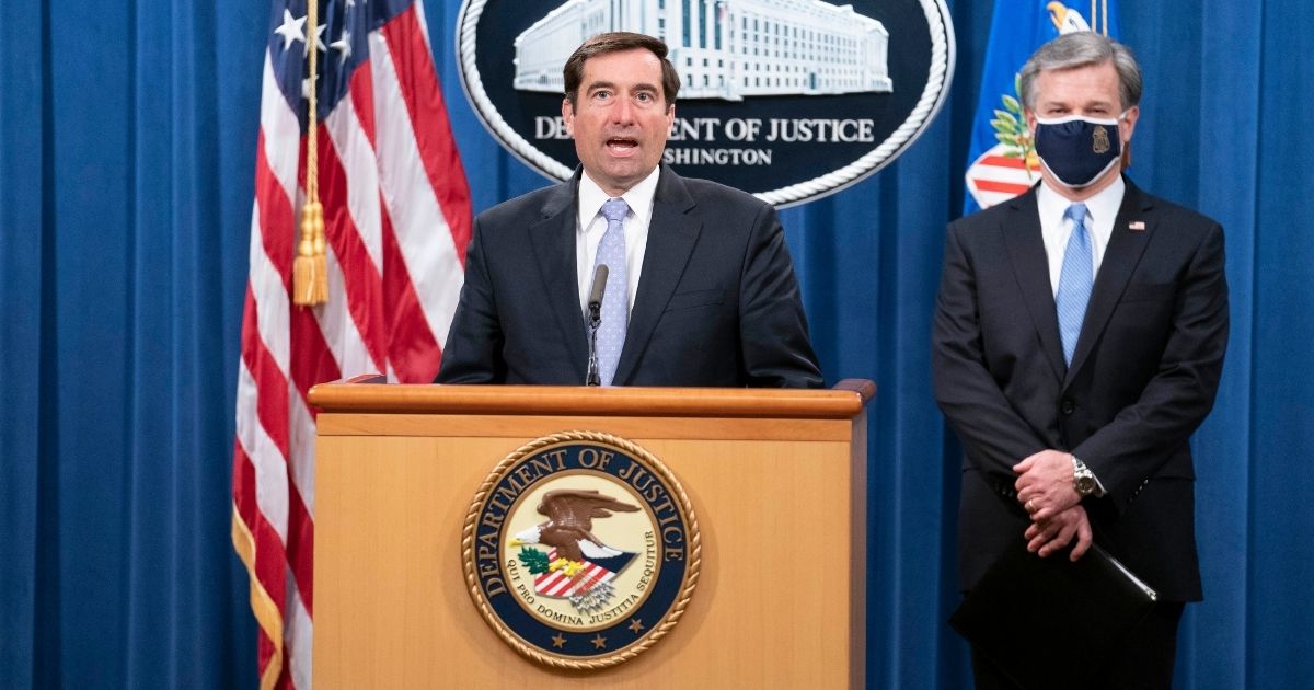 Assistant Attorney General John C. Demers, left, and FBI Director Christopher Wray speak at a news conference at the Department of Justice on Oct. 28, 2020, in Washington, D.C.