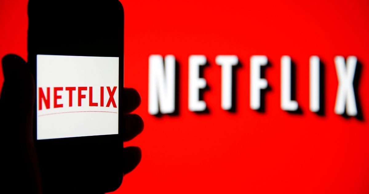 The Netflix logo is seen on the screen of an iPhone in front of a computer screen on Feb. 13, 2019, in Paris, France.