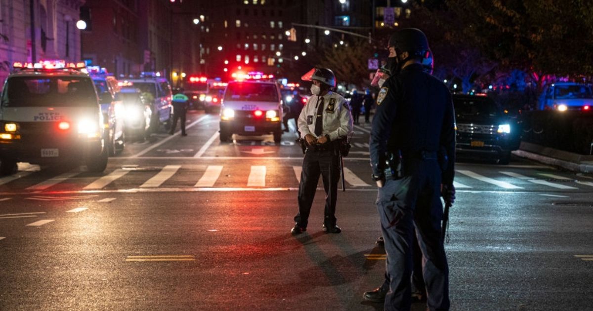 New York Police Department officers stand watch at an intersection on Oct. 27, 2020, following a protest in the Brooklyn borough of New York City.