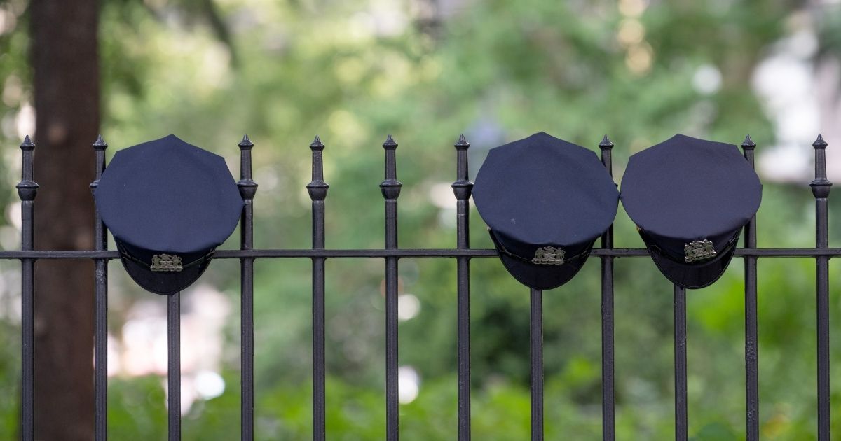 NYPD hats are seen hanging on a fence near City Hall Park on July 26, 2020, in New York City.