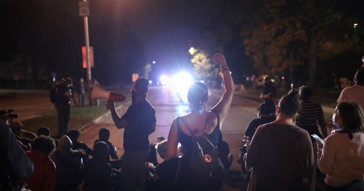 Protesters confront police near Wauwatosa City Hal on Oct. 9, 2020, in Wauwatosa, Wisconsin.