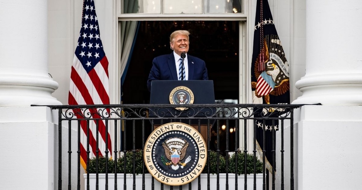 President Donald Trump speaks Saturday from a balcony at the White House.