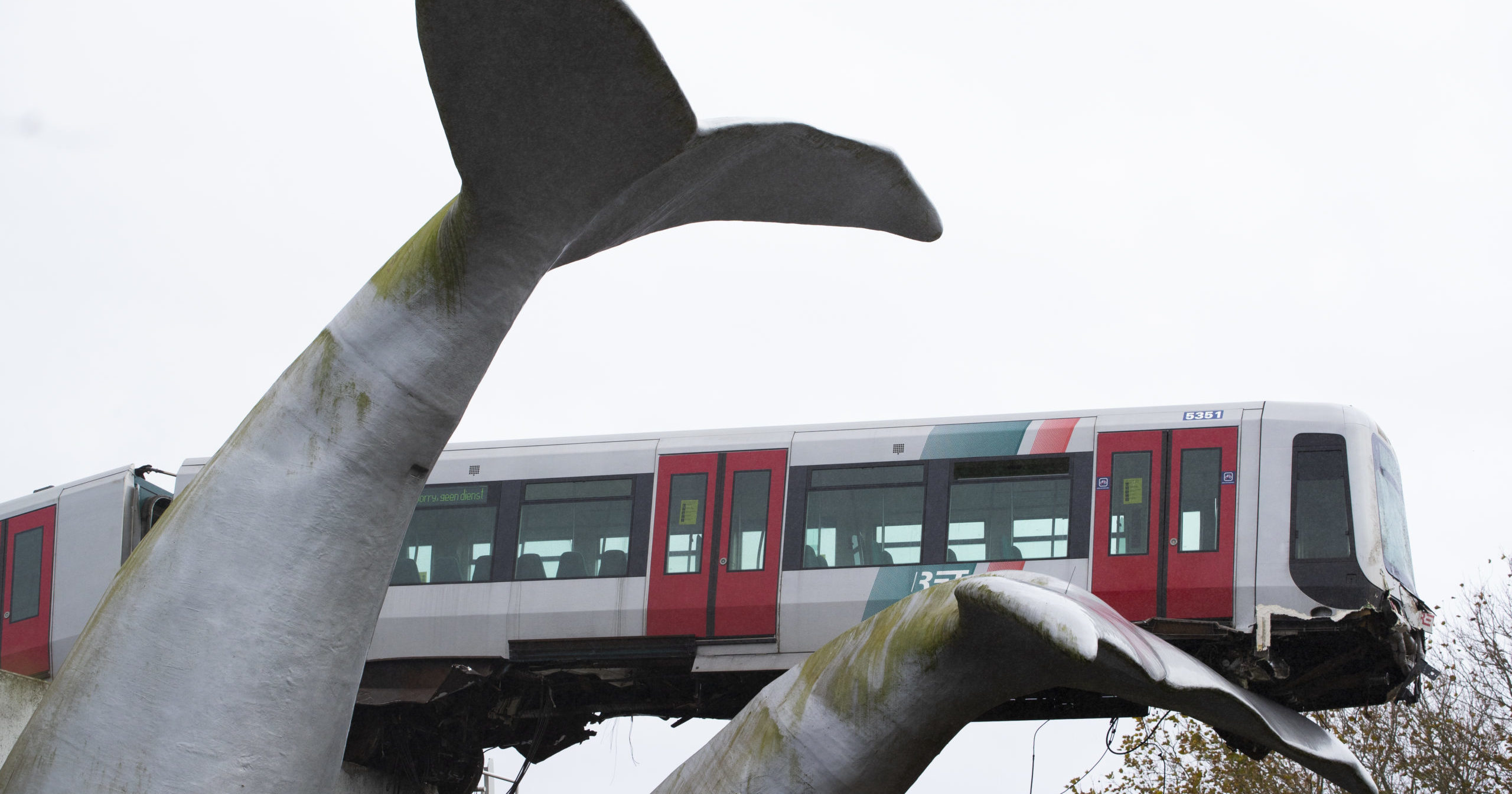 The whale's tail of a sculpture caught the front carriage of a metro train as it rammed through the end of an elevated section of rails with the driver escaping injuries in Spijkenisse, near Rotterdam, Netherlands, on Monday.