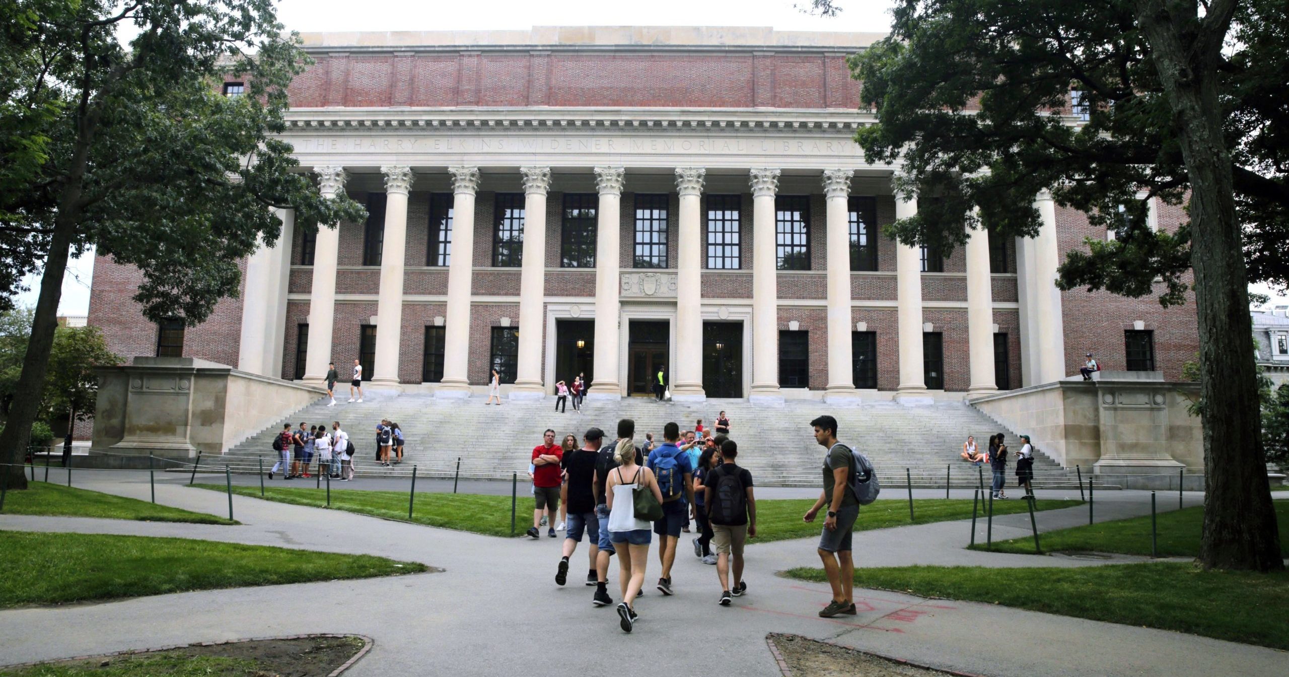 In this Aug. 13, 2019, file photo, students walk on the campus of Harvard University in Cambridge, Massachusetts.