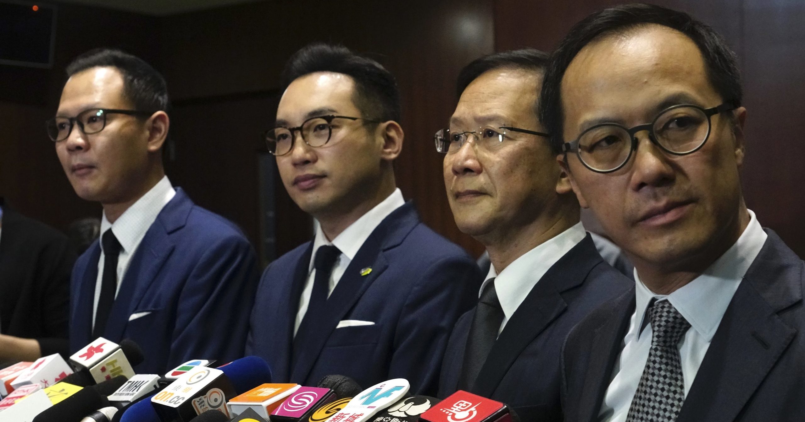 Four pro-democracy lawmakers listen to reporters' questions during a news conference in Hong Kong on Nov. 11, 2020.