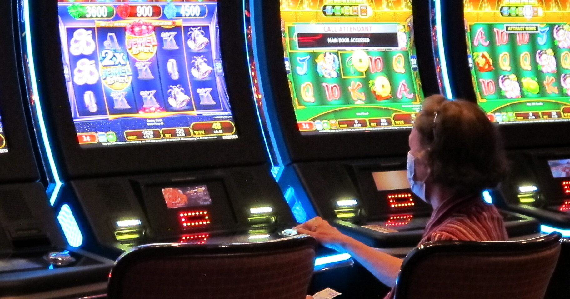 A woman plays a slot machine at the Golden Nugget casino in Atlantic City, New Jersey, on July 2, 2020.