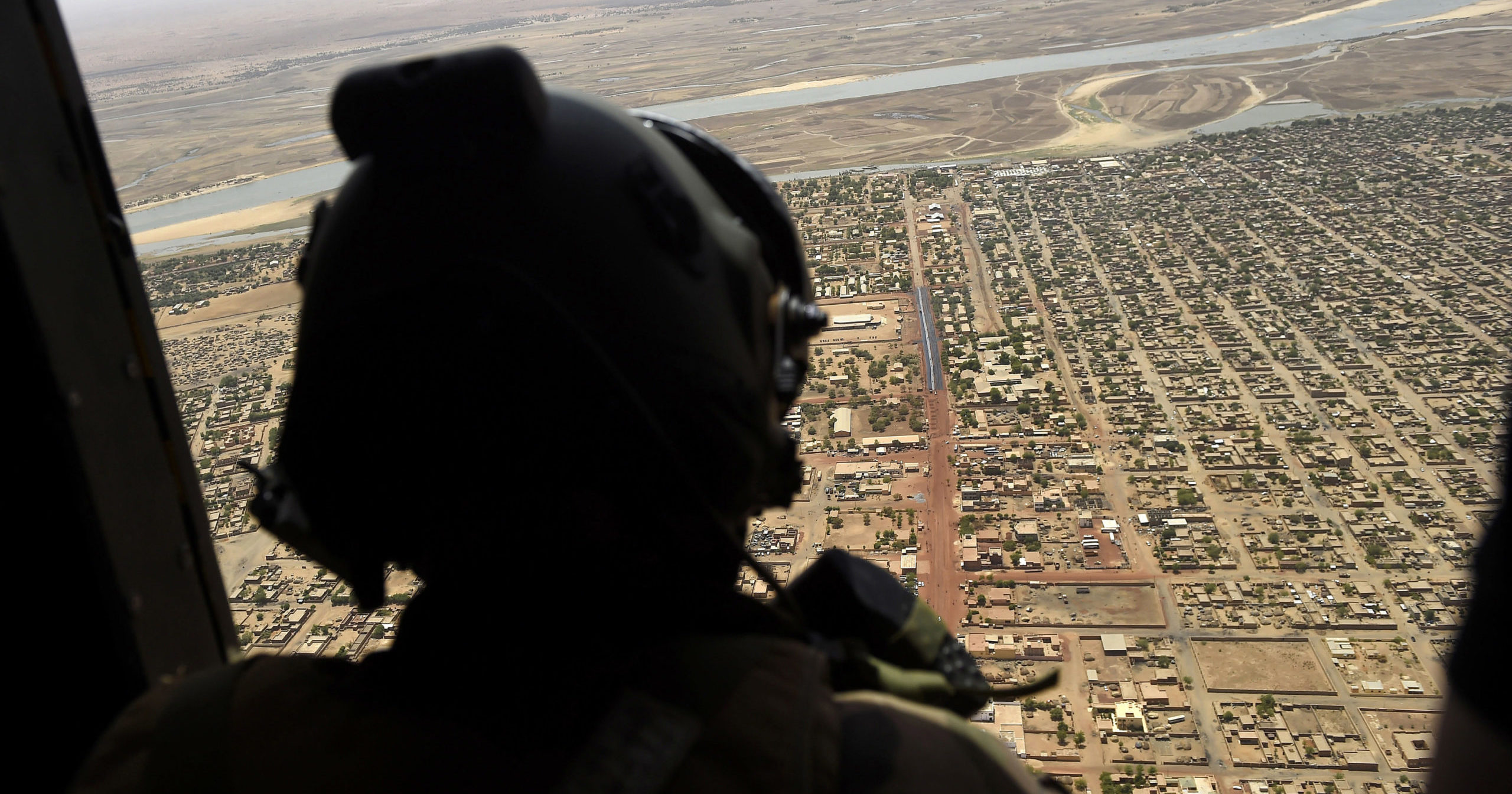 In this May 19, 2017, file photo, a French soldier stands inside a military helicopter during a visit by French President Emmanuel Macron to troops in Mali.