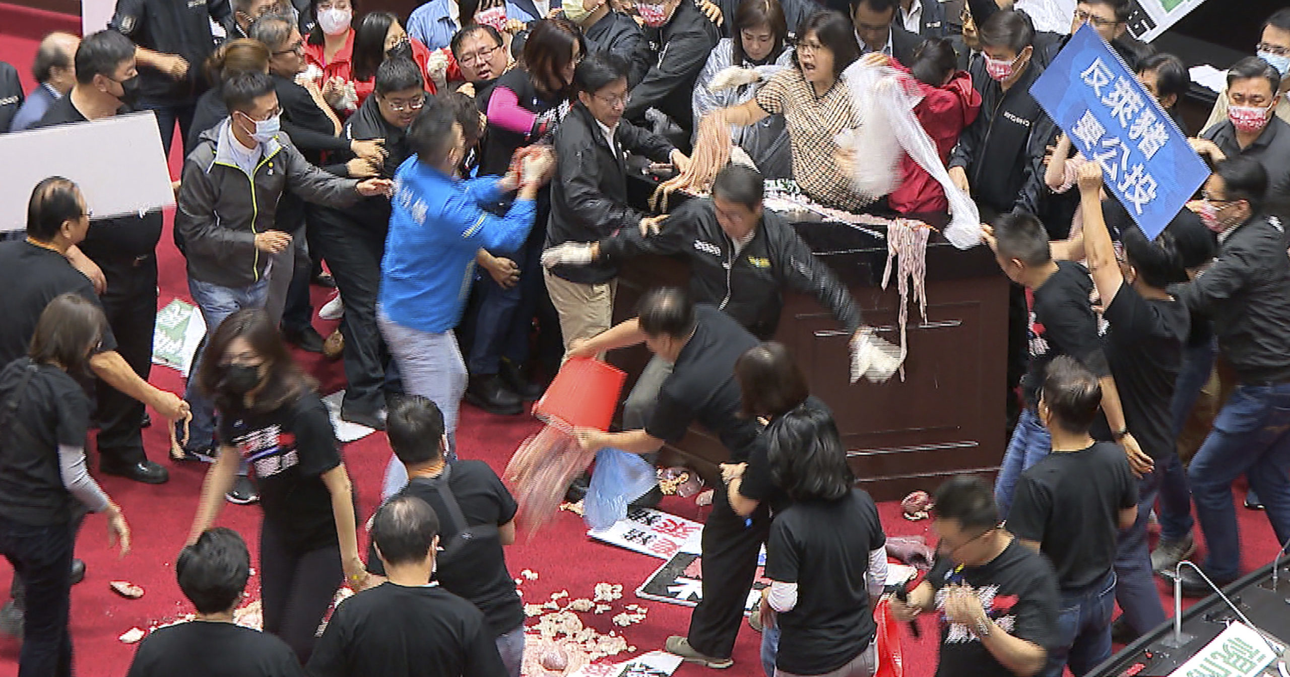 In this image made from video, lawmakers fight during a parliament session in Taipei, Taiwan, on Friday.