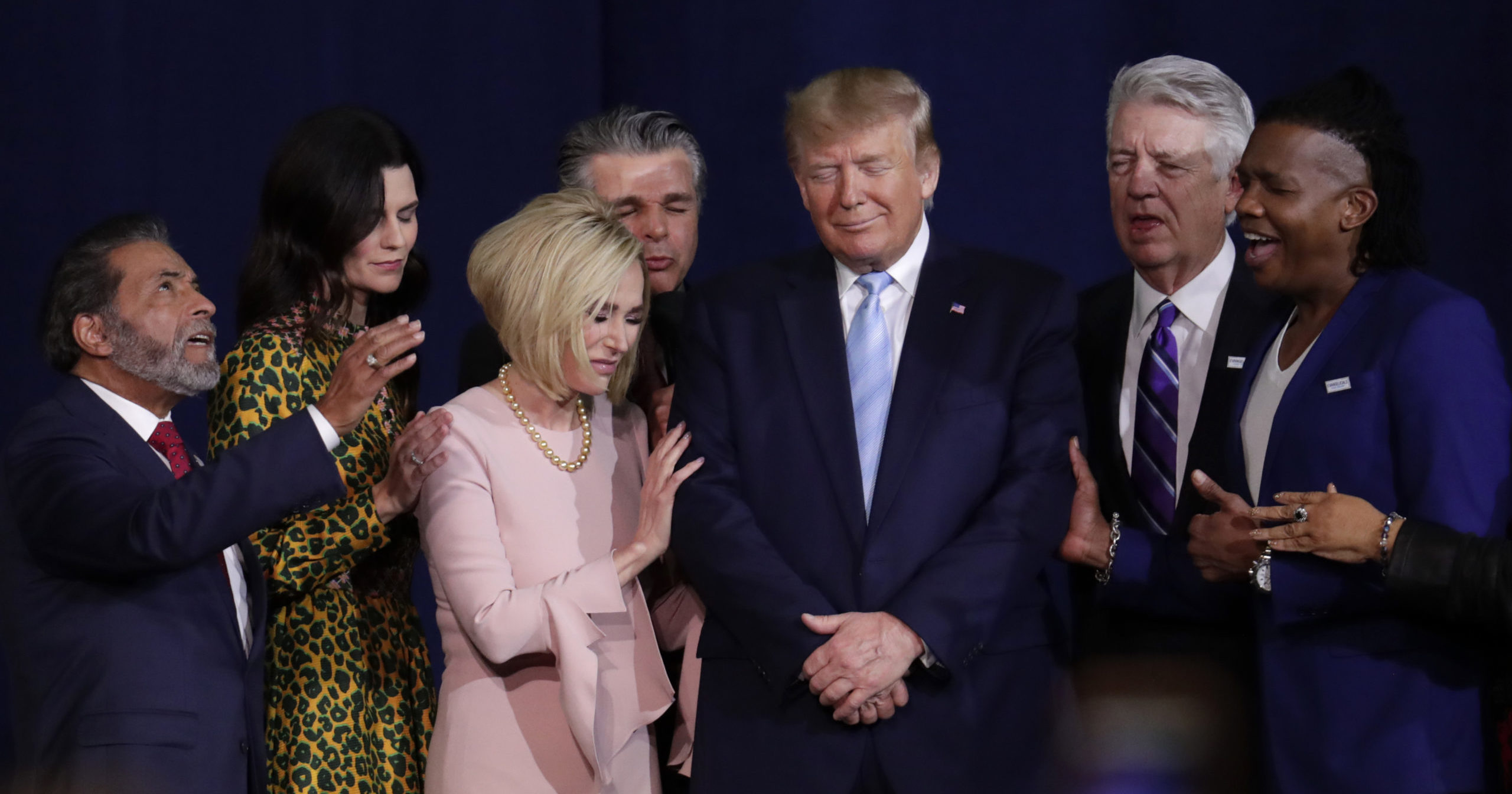 In this Jan. 3, 2020, file photo, faith leaders pray with President Donald Trump during a rally for evangelical supporters at the King Jesus International Ministry church in Miami.