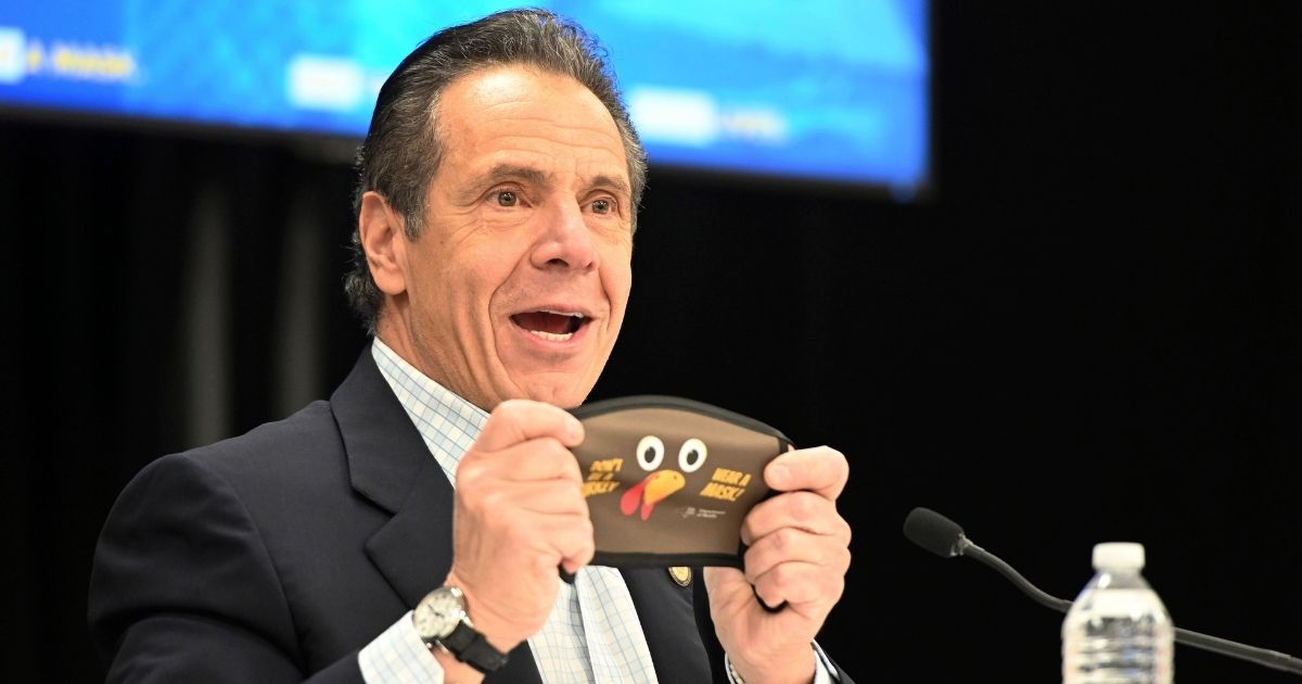 In this provided by the state of New York, New York Gov. Andrew Cuomo holds up a new Thanksgiving-themed face mask during his daily coronavirus briefing at the Wyandanch-Wheatley Heights Ambulance Corp. Headquarters in Wyandanch, New York.