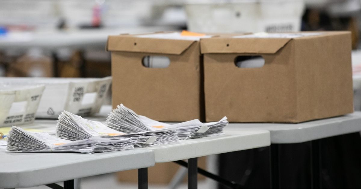 A stack of ballots is in the process of being counted at the Gwinnett Voter Registrations and Elections office in Lawrenceville, Georgia, on Friday.