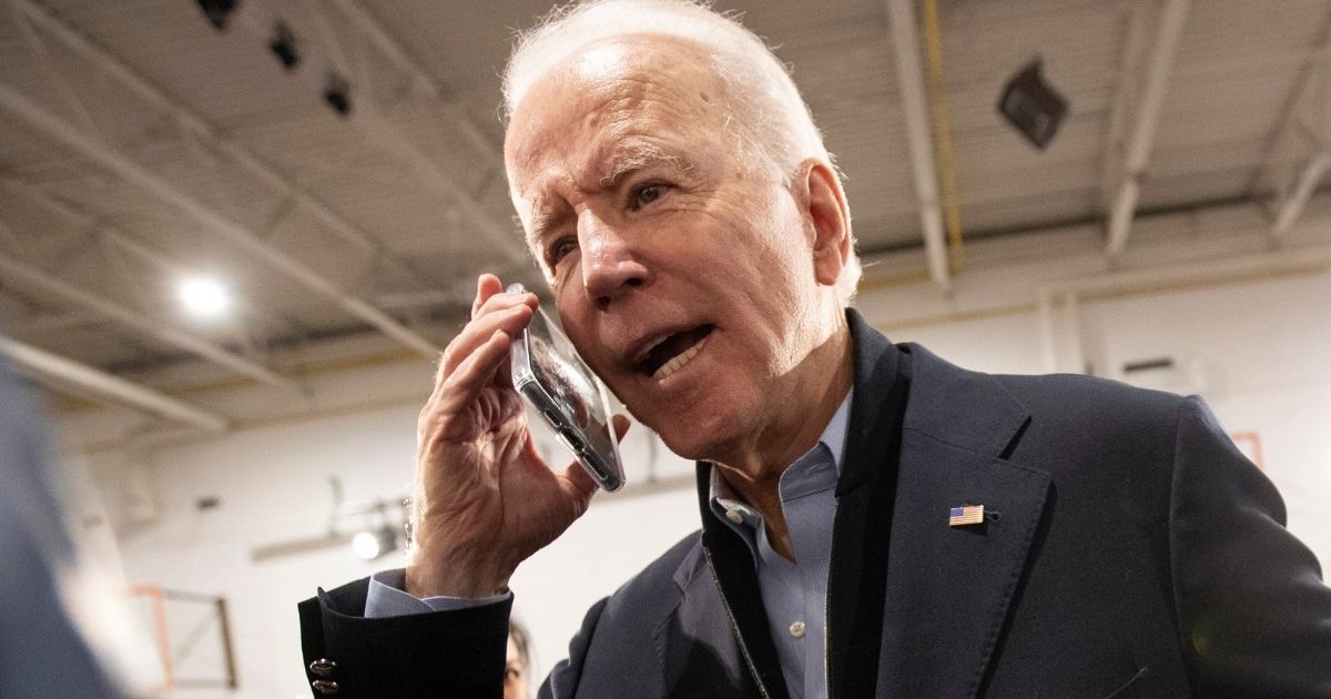 Democratic presidential candidate Joe Biden speaks on the phone during a campaign stop in Nashua, New Hampshire, on Feb. 4.
