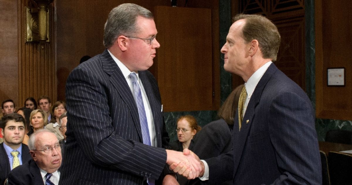 Sen. Pat Toomey, right, shakes hands with Matthew Brann at his confirmation hearing in 2012.