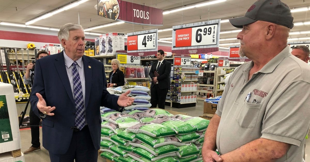 In this May 7 photo, Republican Missouri Gov. Mike Parson, left, talks with store manager Ron Schuman, right, during a tour of the Orscheln Farm & Home store in Jefferson City, Mo.
