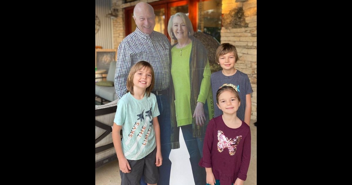 Cardboard cutout grandparents Missy and Barry Buchanan with their grandchildren.
