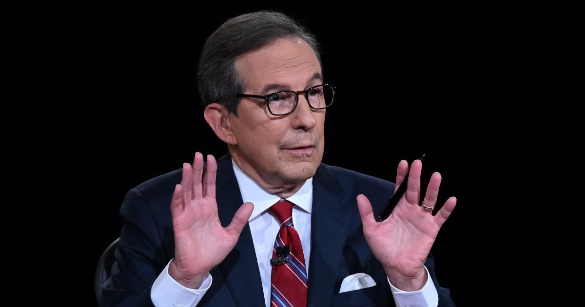 Debate moderator and Fox News anchor Chris Wallace directs the first presidential debate between President Donald Trump and Democratic presidential nominee Joe Biden at the Health Education Campus of Case Western Reserve University on Sept. 29, 2020, in Cleveland.