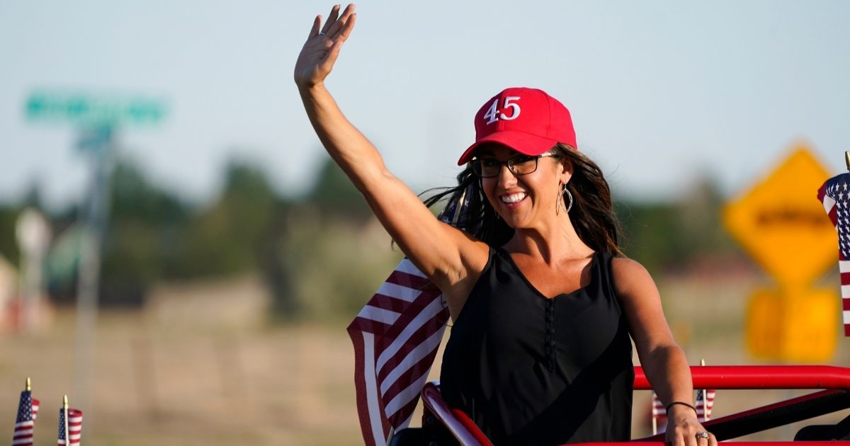 Republican congressional candidate Lauren Boebert waves during a "freedom cruise" staged by her supporters Sept. 4 in Pueblo West, Colorado.