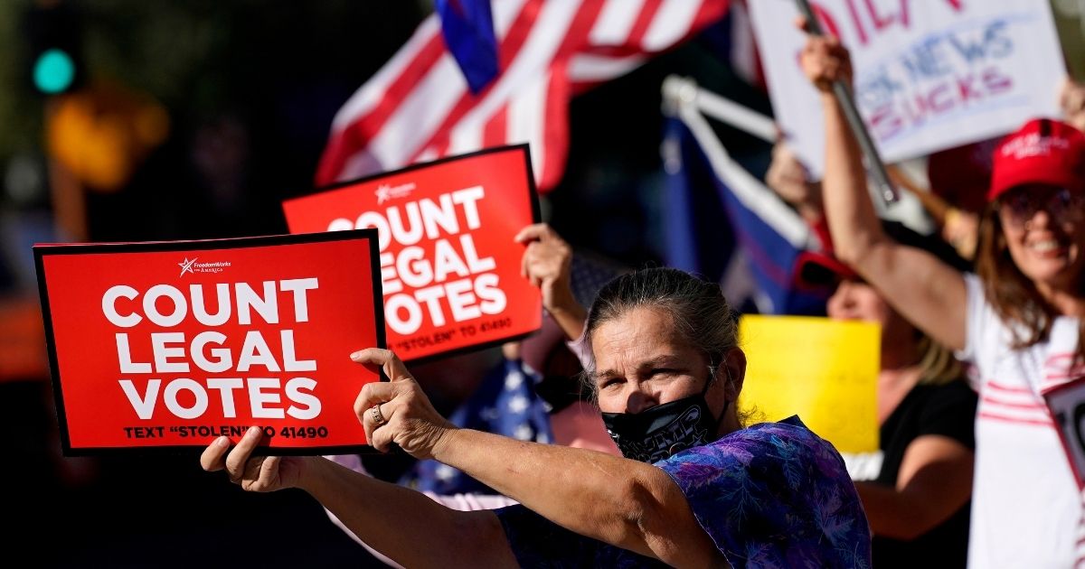 People rally outside City Hall on Thursday in Phoenix.