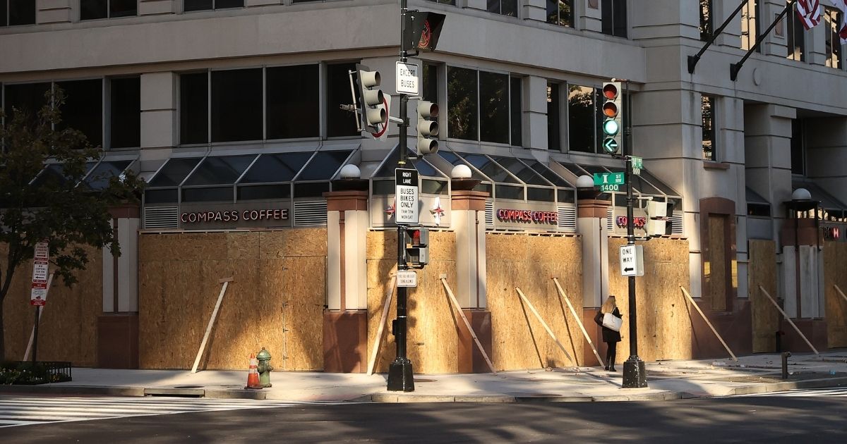 Retail businesses and office buildings are boarded up in anticipation of Election Day vandalism near the center of the nation’s capital on Monday.