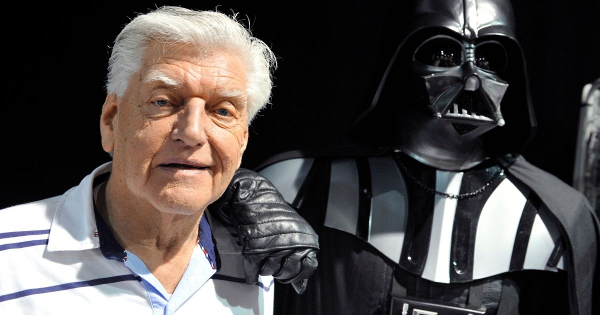 English actor David Prowse, left, who played the character of Darth Vader in the first Star Wars trilogy poses with a fan dressed up in a Darth Vader costume during a Star Wars convention on April 27, 2013, in Cusset.