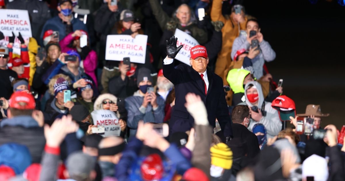 President Donald Trump waves to supporters during a campaign rally on Nov. 2, 2020, in Traverse City, Michigan.