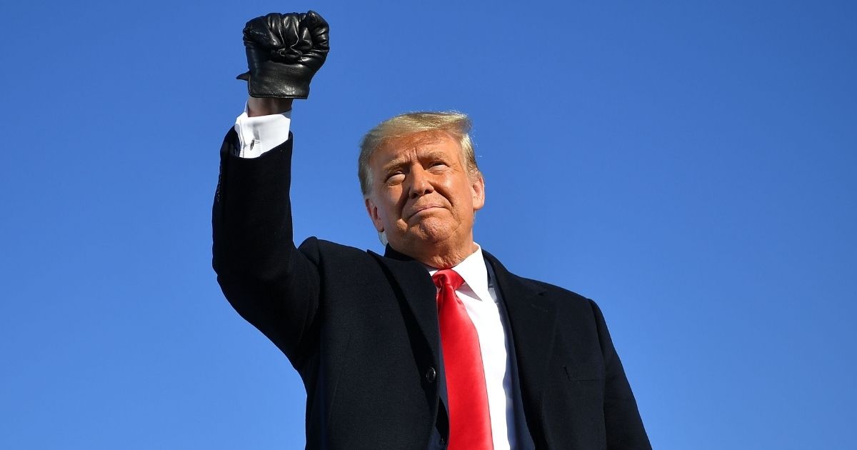 President Donald Trump pumps his fist as he arrives for a campaign rally at Green Bay Austin Straubel International Airport in Green Bay, Wisconsin, on Oct. 30.