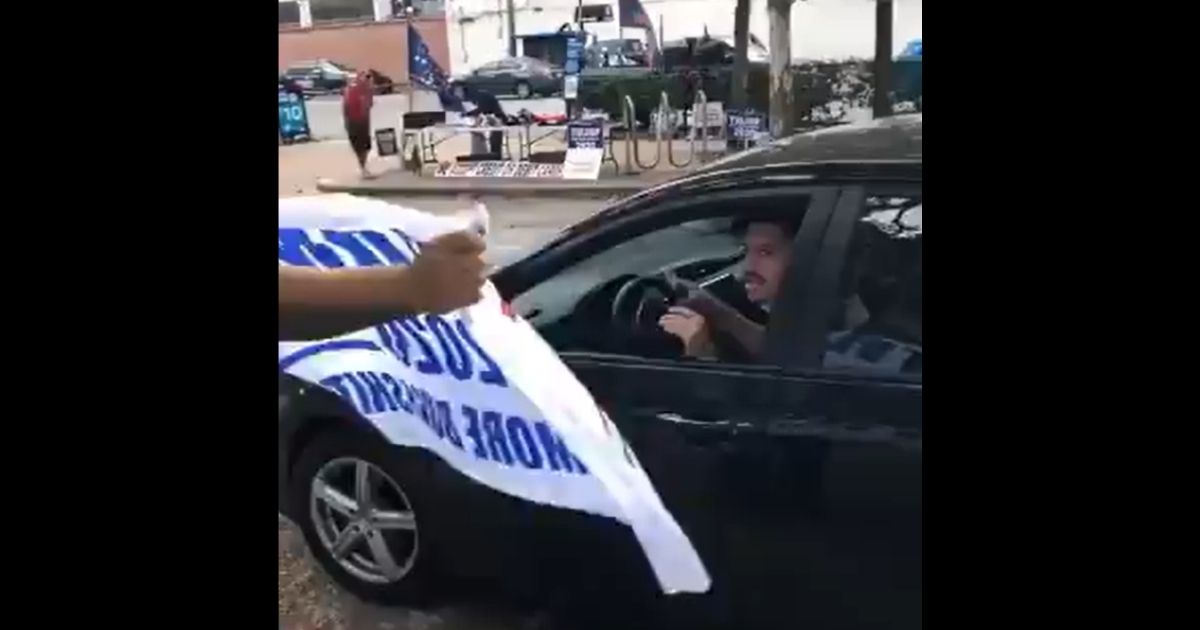 A driver argues with Trump supporters.