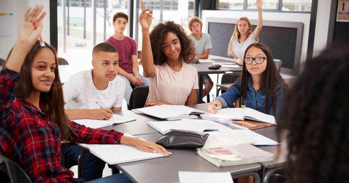High school students listen during class in the stock image above.