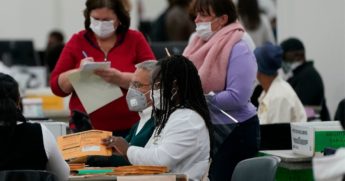 Mail-in ballots in the presidential election are processed at the central counting board in Detroit on Nov. 4.