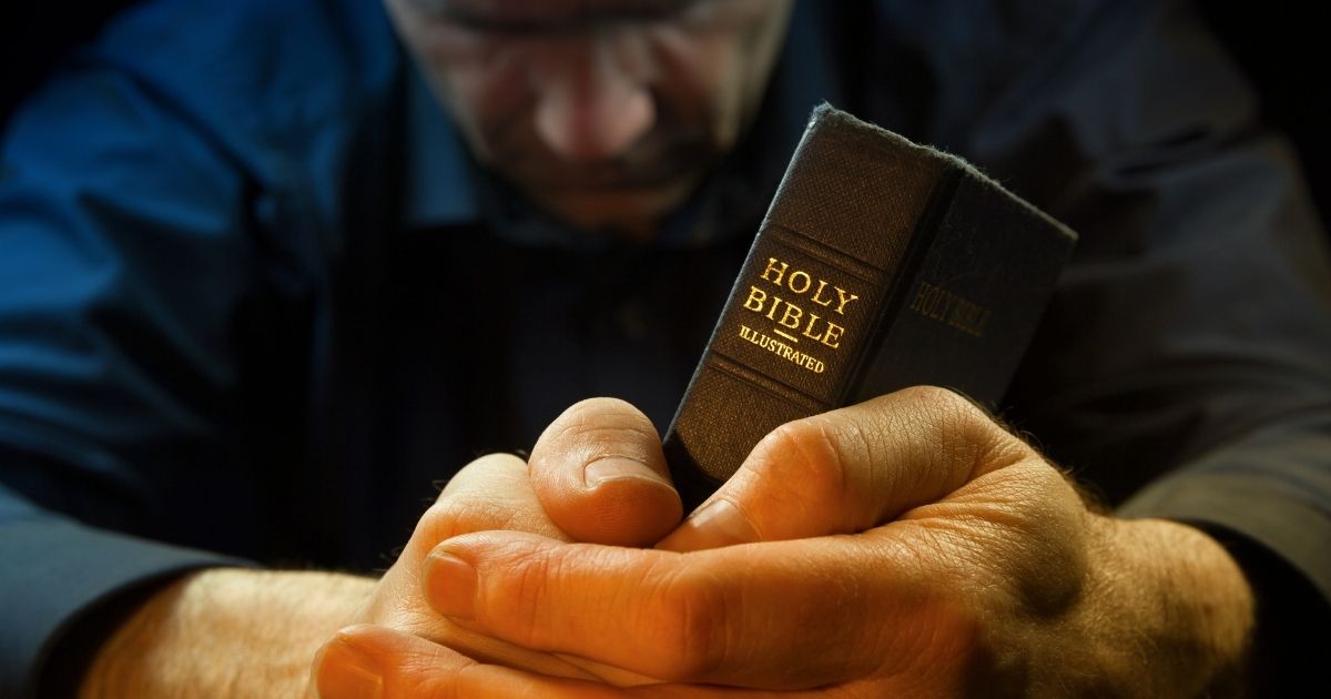 A man prays in the stock image above.