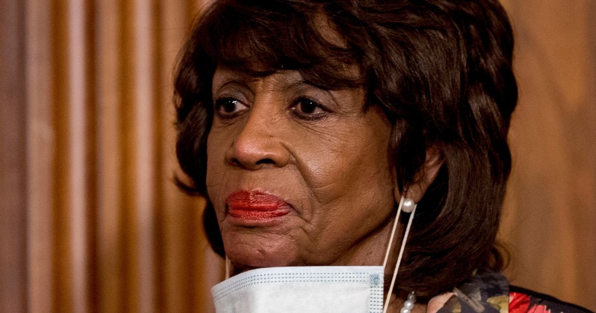 Democratic Rep. Maxine Waters takes her mask off to speak during a signing ceremony on Capitol Hill in Washington on April 23.