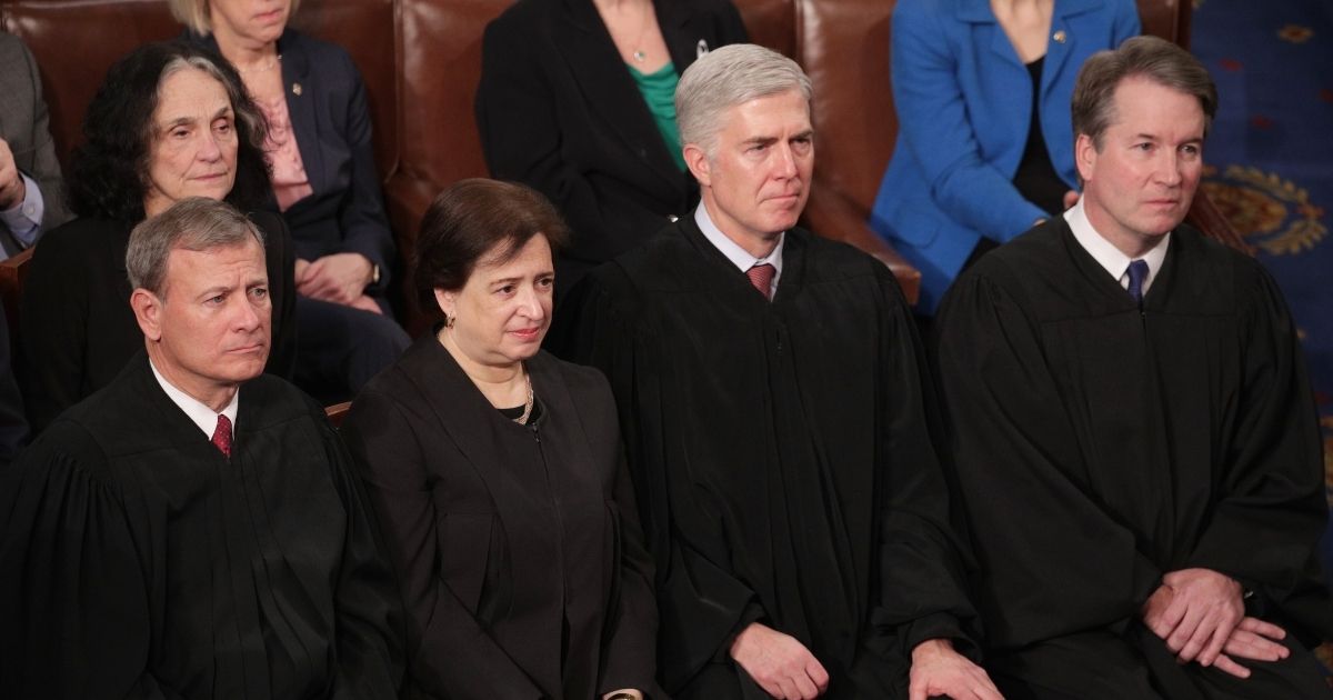 Supreme Court Justices John Roberts, Elena Kagan, Neil Gorsuch, and Brett Kavanaugh look on as President Donald Trump delivers the State of the Union address in the chamber of the U.S. House of Representatives on Feb. 5, 2019 in Washington, D.C.